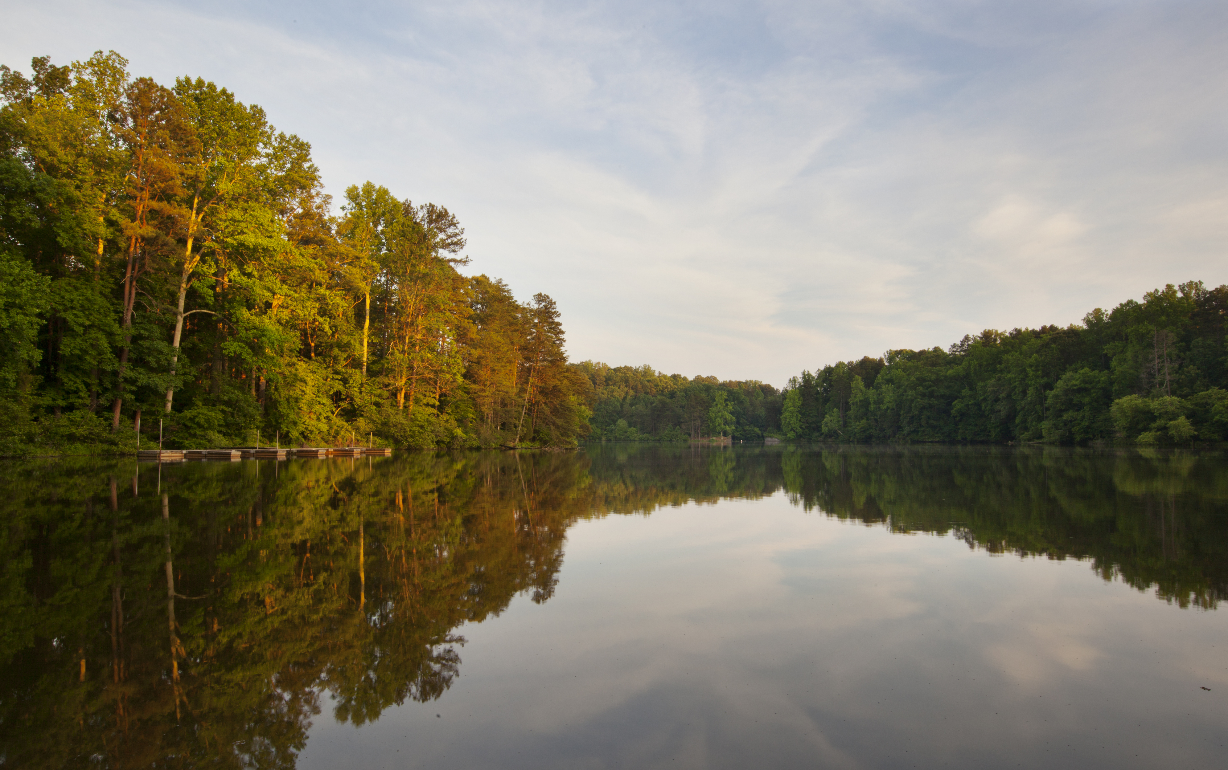 Peaceful view of Lake Norman in North Carolina with calm blue water and distant shoreline symbolizing hidden history beneath the lake