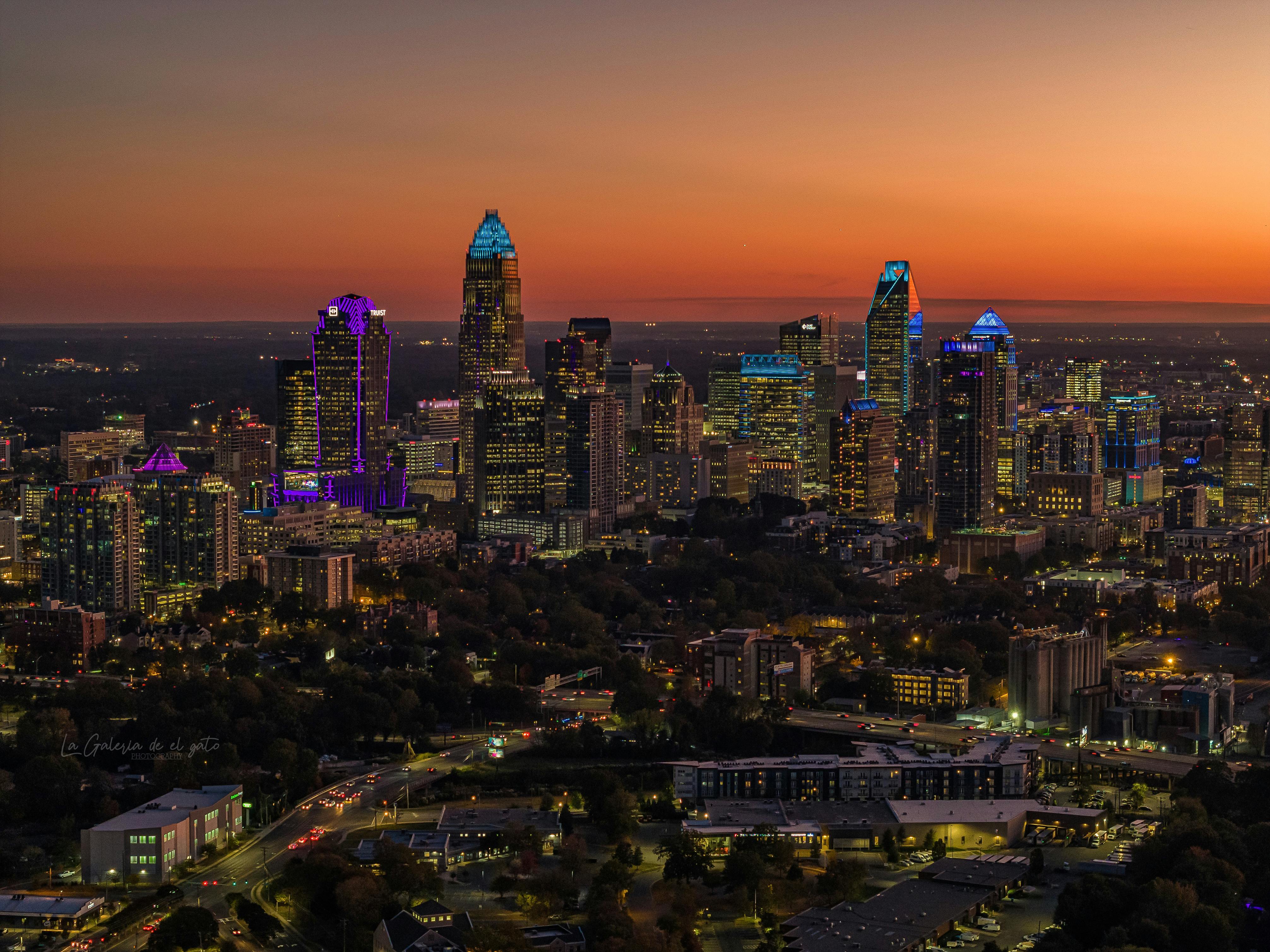 Charlotte, North Carolina skyline at night with illuminated skyscrapers and city lights.