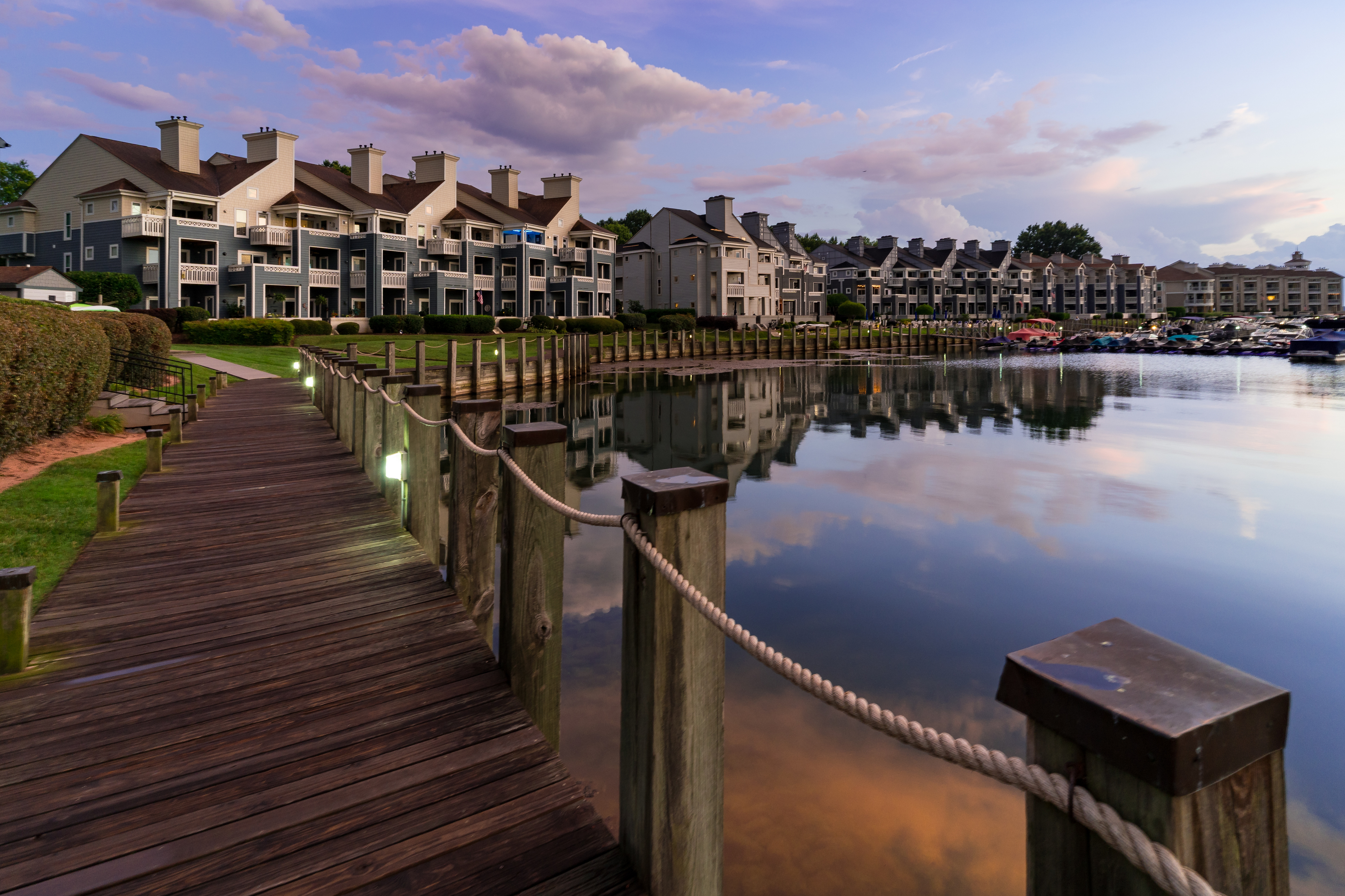 Peaceful view of Lake Norman in Cornelius NC with calm blue water boats and tree lined shores on a clear Carolina day