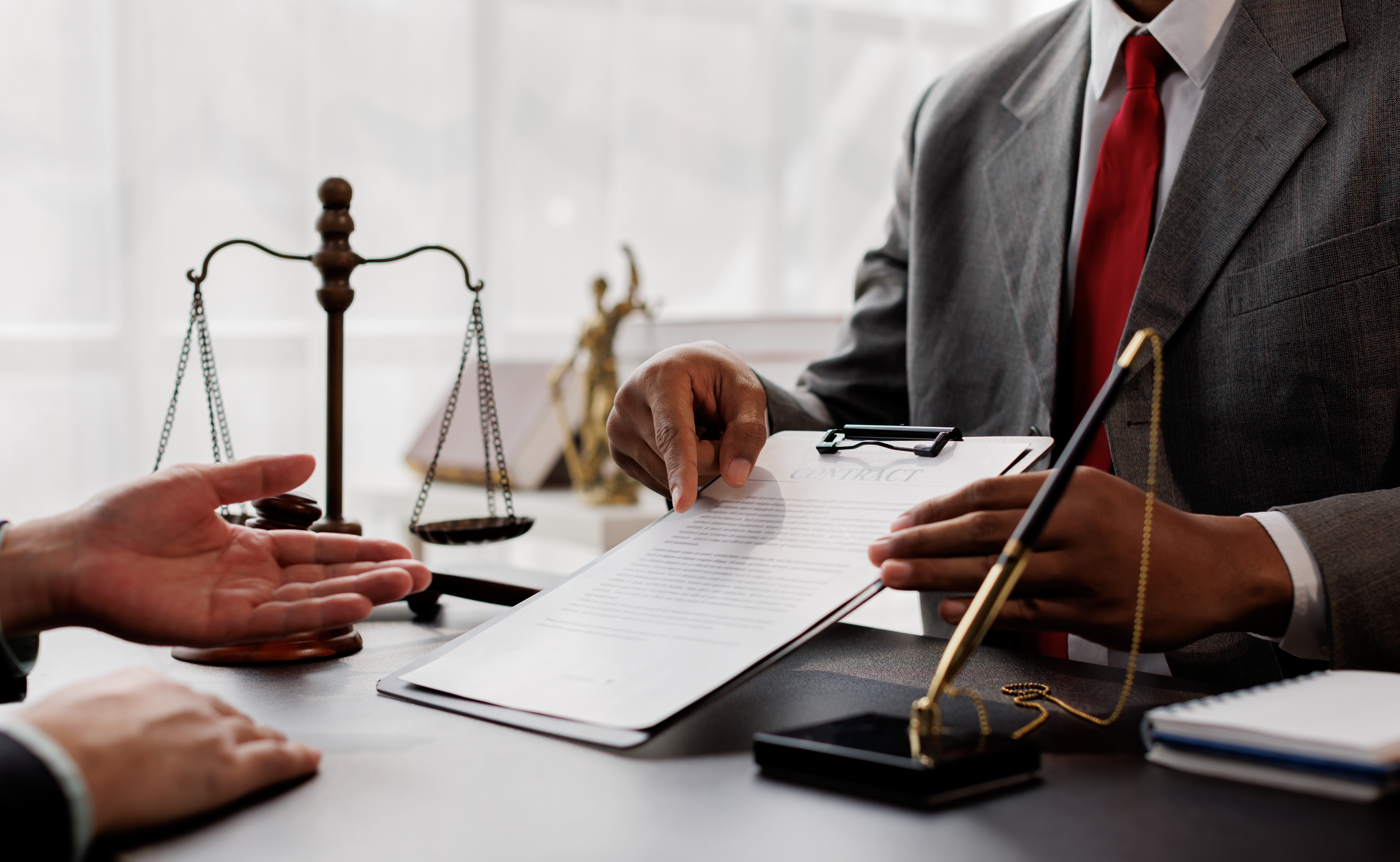 Man sitting with attorney in office reviewing financial documents and calculating child support payments in Huntersville North Carolina