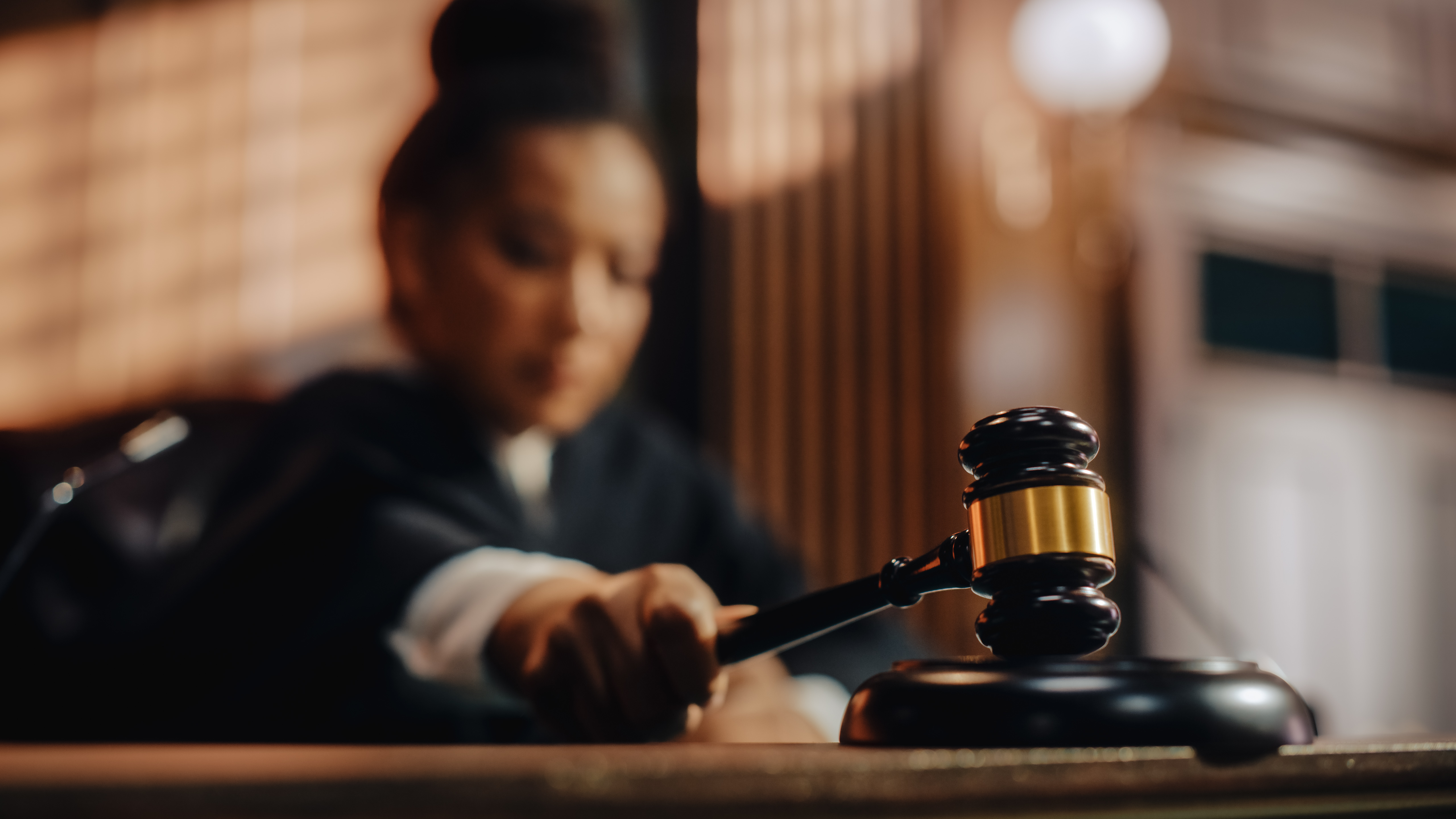Close up of a judge holding a gavel in a Mecklenburg County courtroom symbolizing impartiality and judicial recusal in North Carolina courts