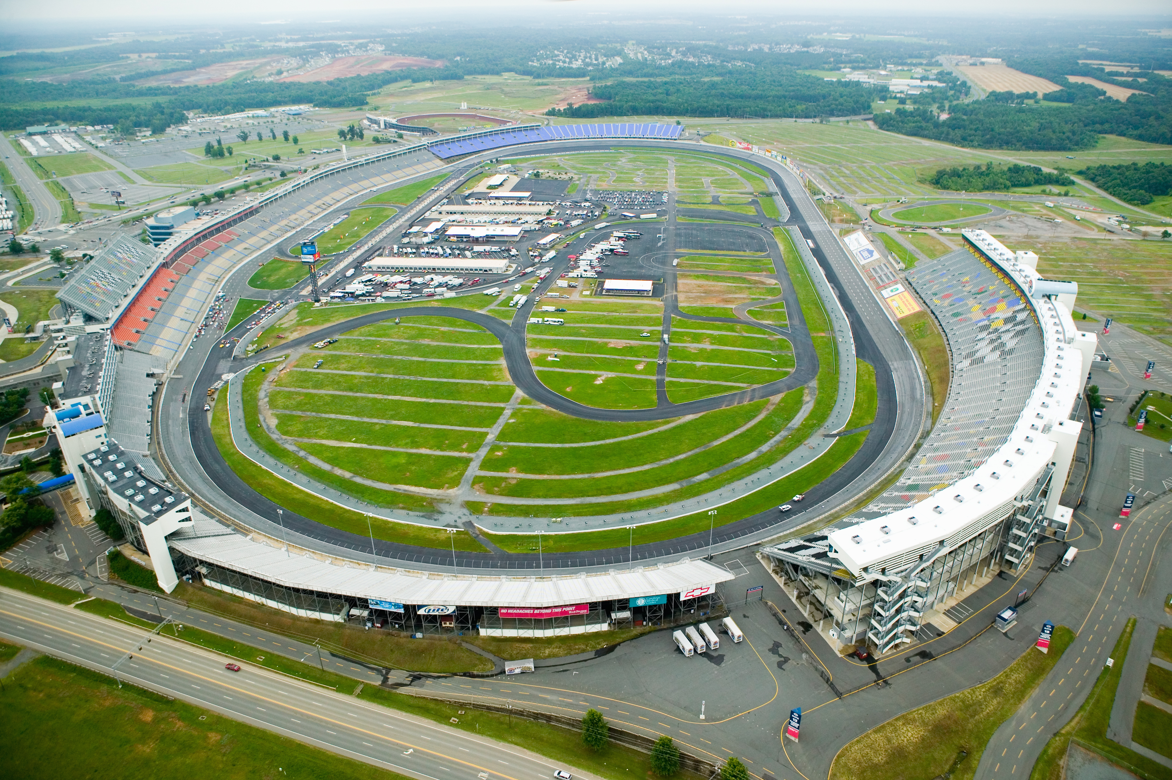 Aerial view of Charlotte Motor Speedway in Concord North Carolina with racetrack grandstands and infield during the day