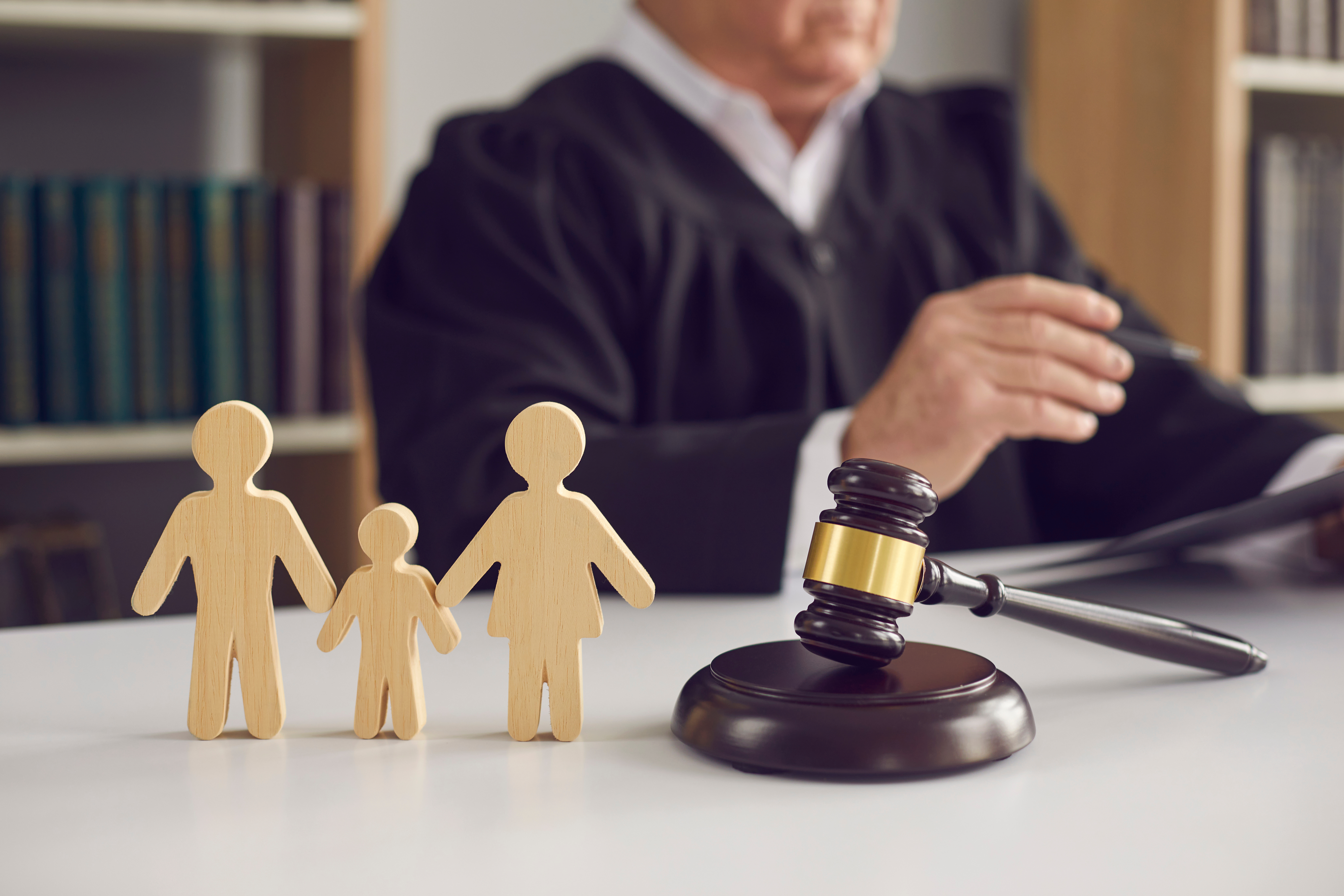 Family Custody Trial in Huntersville NC LKN Law Judges gavel beside paper cutout family figures symbolizing a North Carolina custody case in a Huntersville courtroom
