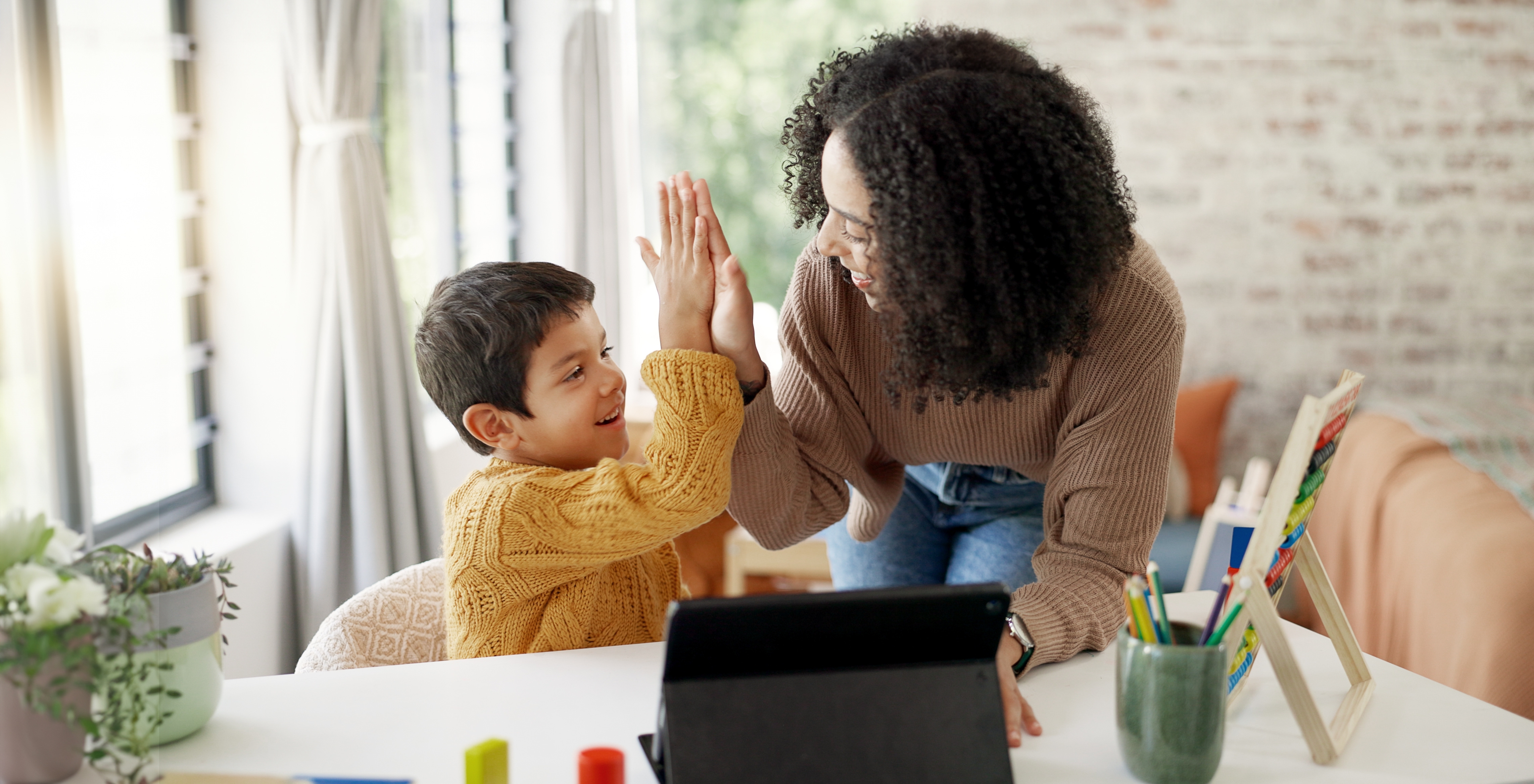 Smiling mother and child sitting together at home in Huntersville NC representing financial stability and support after a successful child support case