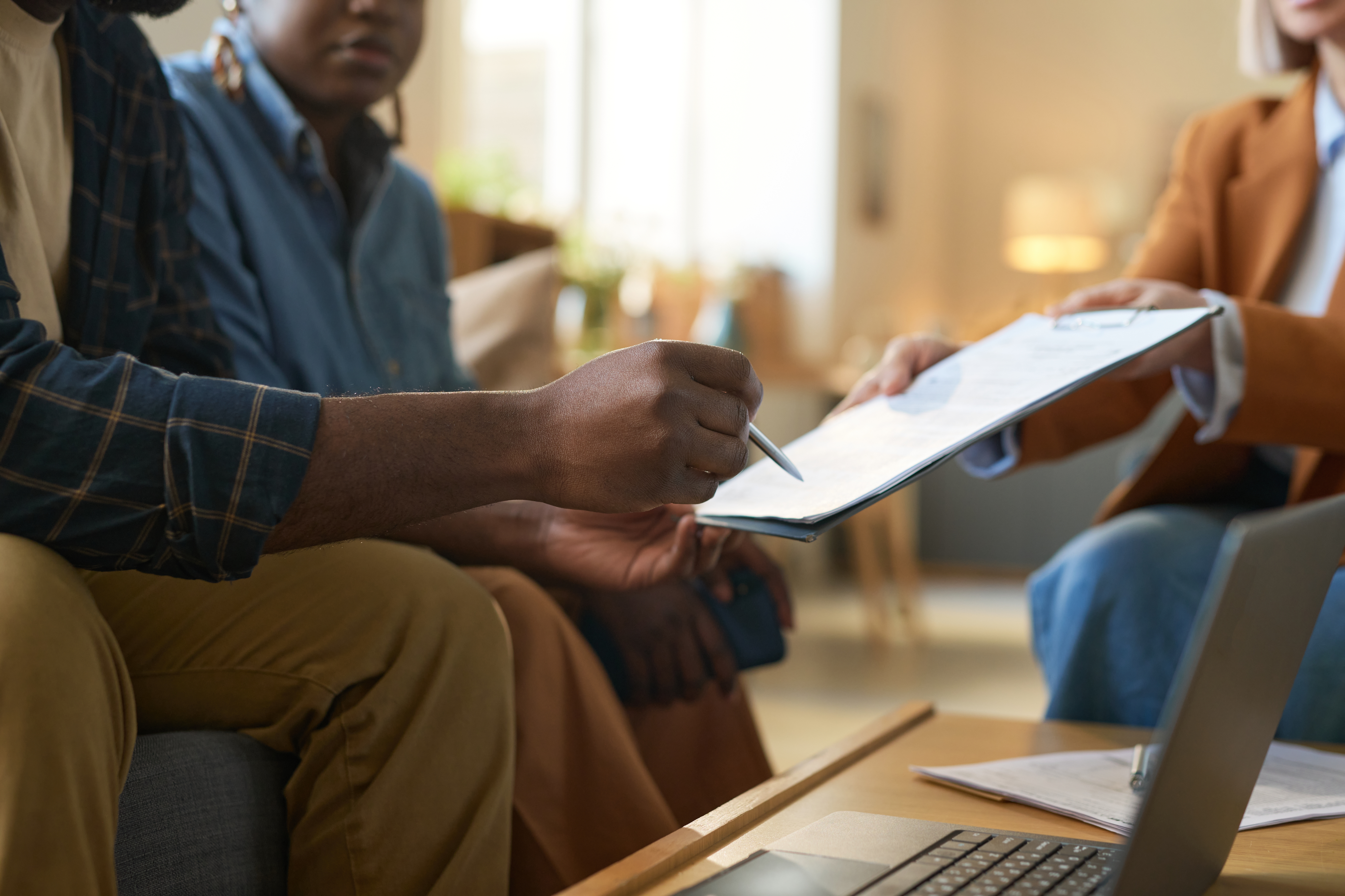 Family sitting at a table signing child custody papers with an attorney in Iredell County North Carolina
