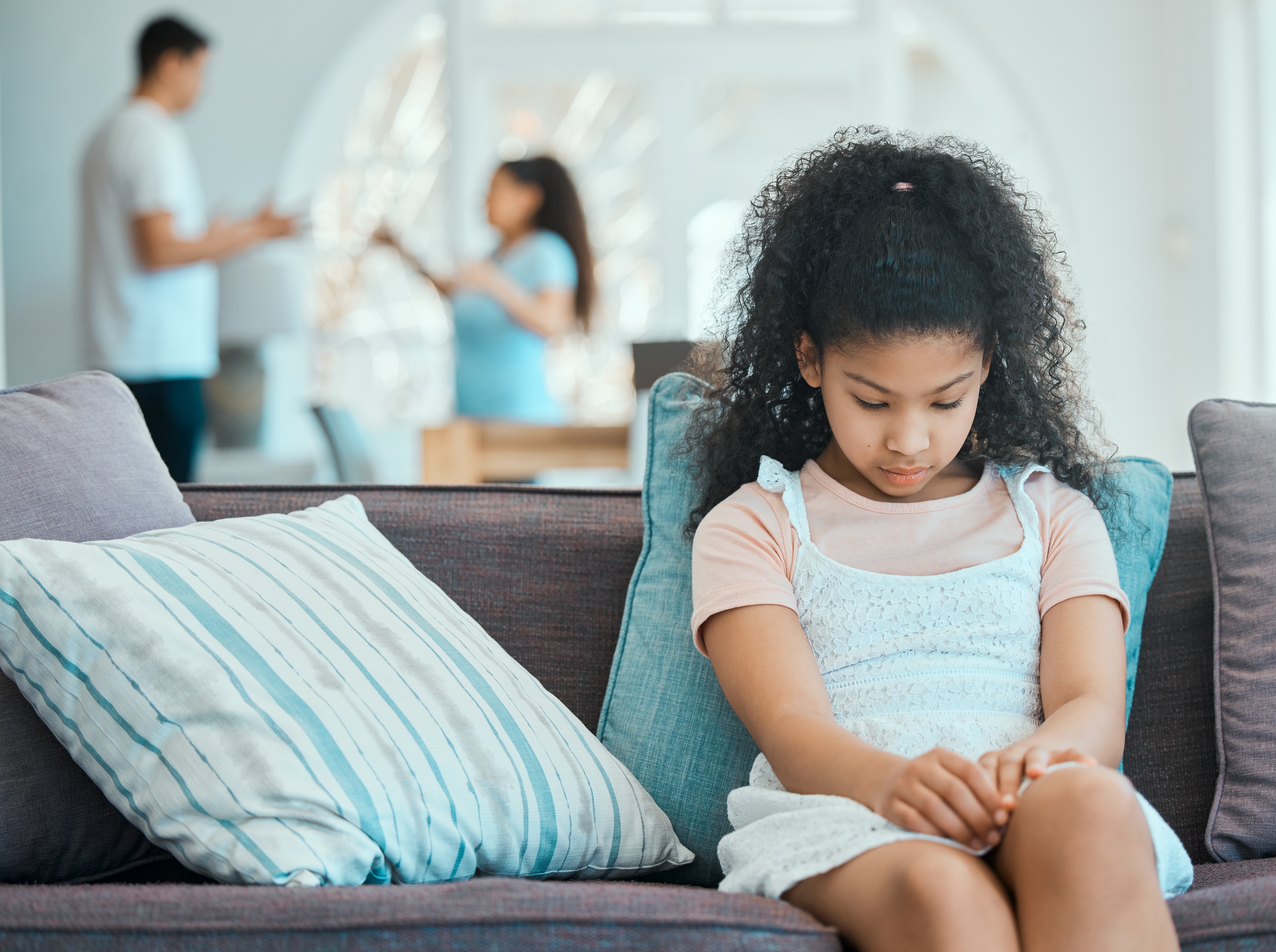 Young child sitting alone with a thoughtful expression symbolizing a custody battle in Sherrills Ford North Carolina
