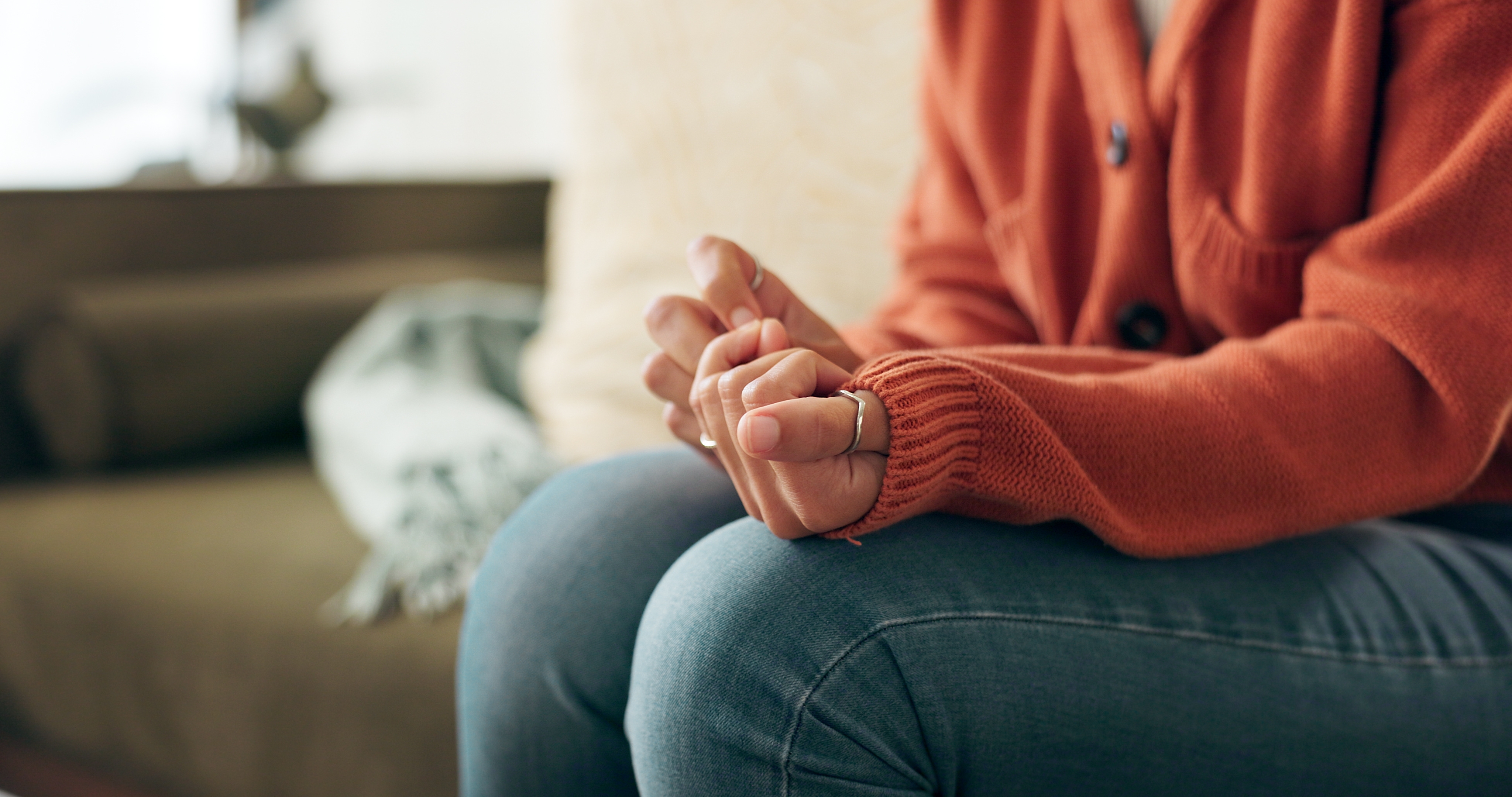 Woman sitting alone and distressed after divorce, showing signs of PTSD and emotional trauma in Huntersville, North Carolina.