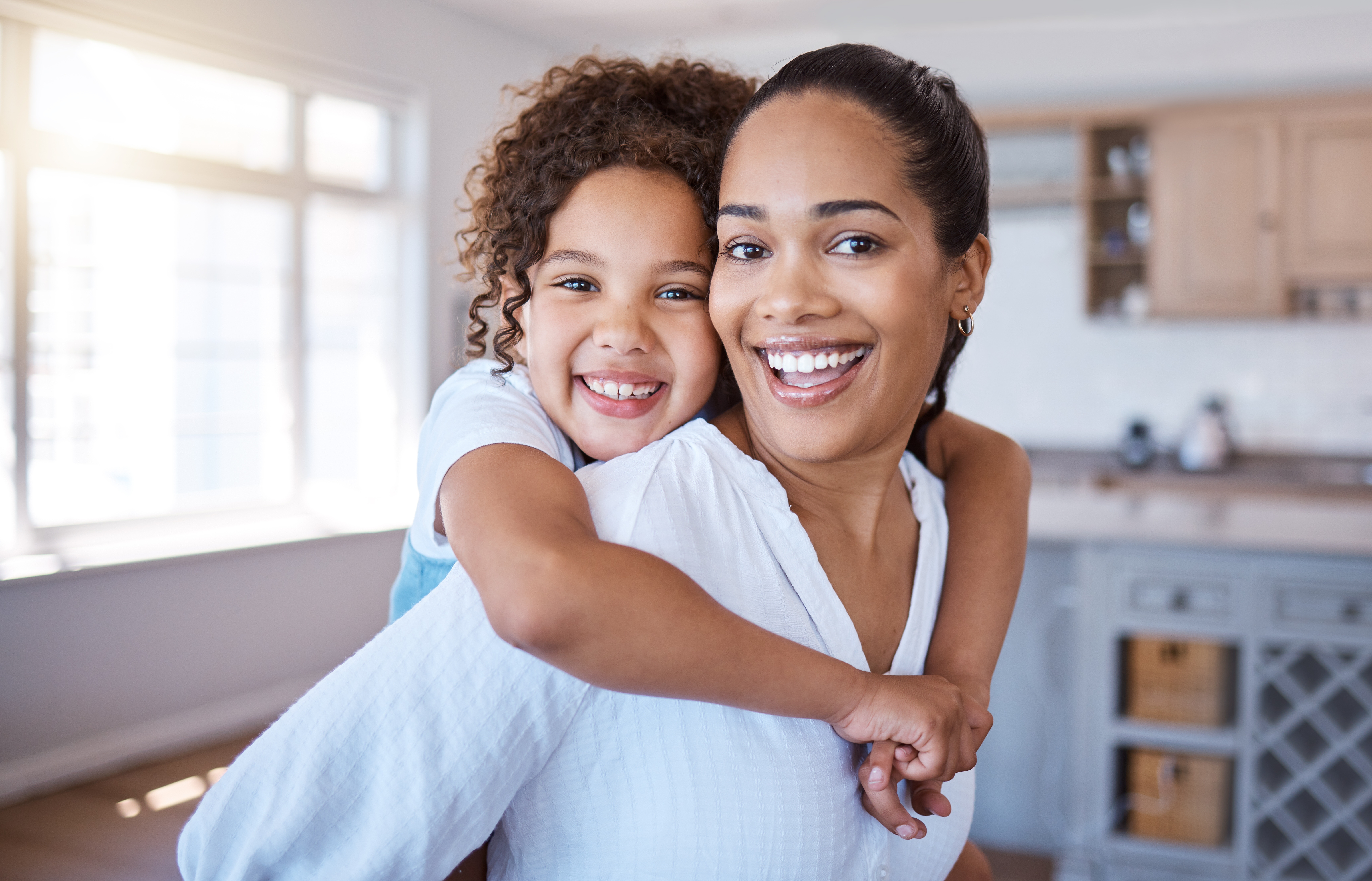 “Mother and child smiling outside after a successful child support case resolved by Adkins Law in Huntersville, North Carolina