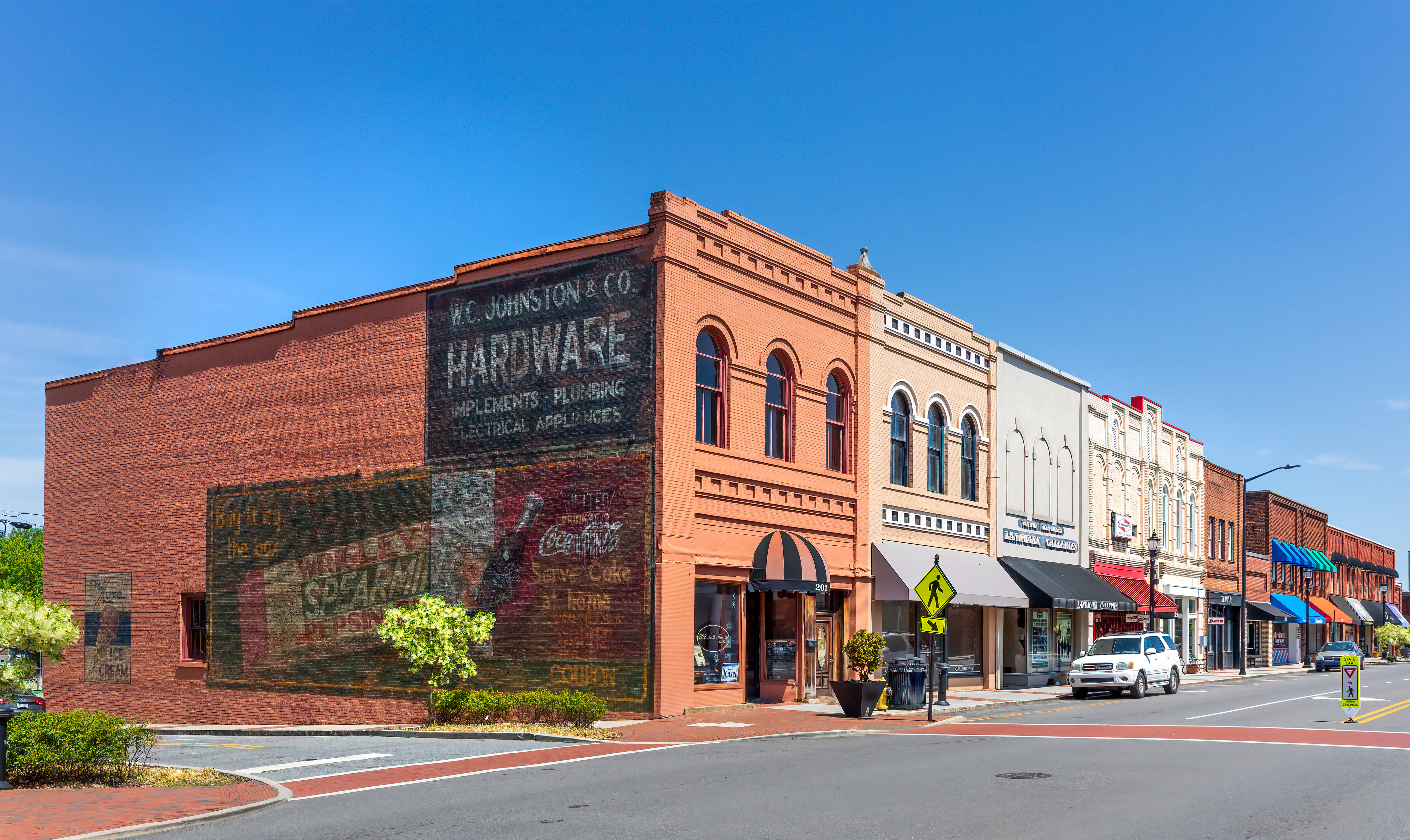 Historic downtown Mooresville, North Carolina, featuring restored brick buildings, local shops, and a view along Main Street
